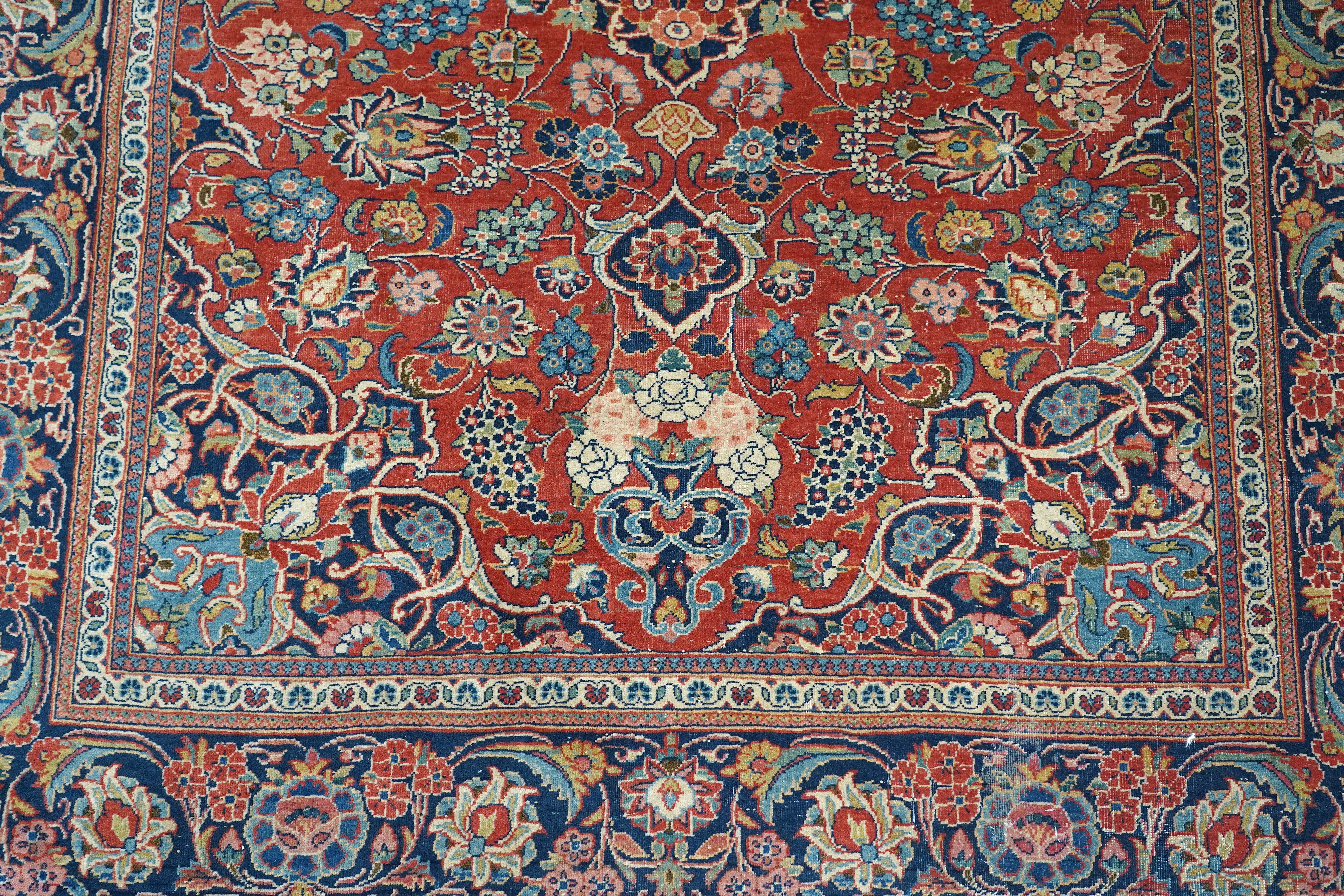 A pair of antique Tabriz brick red ground rugs, 200 x 136cm. Condition - fair